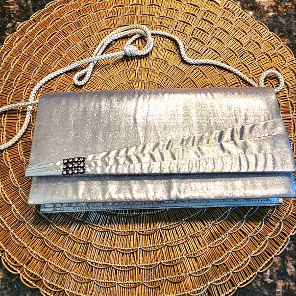 Handbags - Beautiful silver clutch with rhinestones on the side. Used